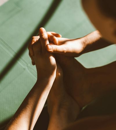Close-up of a person's feet on a yoga mat, showing stability and focus.